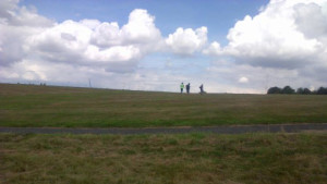 Three boys going up a hill to play football
