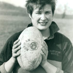 Woman holding a rugby ball