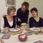 Two ladies seated with food on their plates and a third, between them, serving them. For Jo Ind's blog - What is a writer?